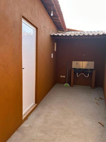 an empty room with a door and a table in it at Casita lagoa paraíso in Jijoca de Jericoacoara