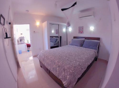 a bedroom with a large bed in a white room at The garden gate resort & apartments no 3 in Negombo