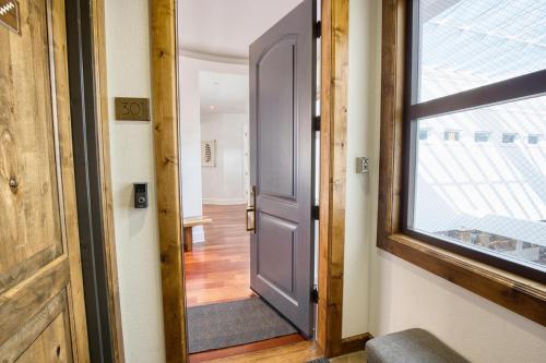 an open door in a room with a window at Luxe Ketchum Penthouse with Rooftop Hot Tub in Ketchum