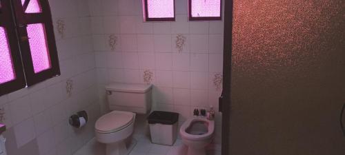 a bathroom with a toilet and a bidet at LA MANSION in Manizales