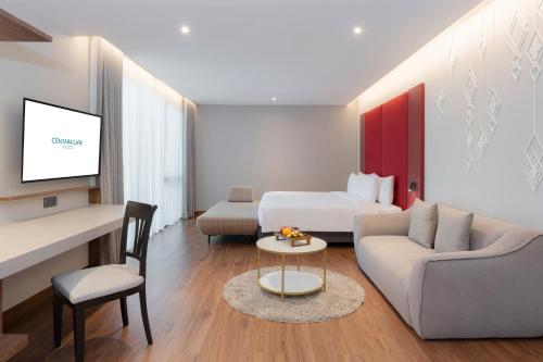 a hotel room with a bed and a couch at Centara Life Hotel Bangkok Phra Nakhon in Bangkok