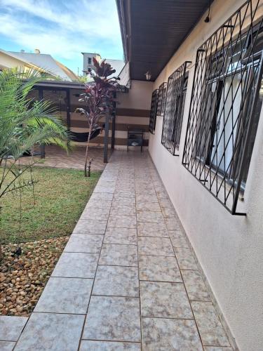 a walkway outside of a house with wrought iron gates at Casa Feliz in Cascavel