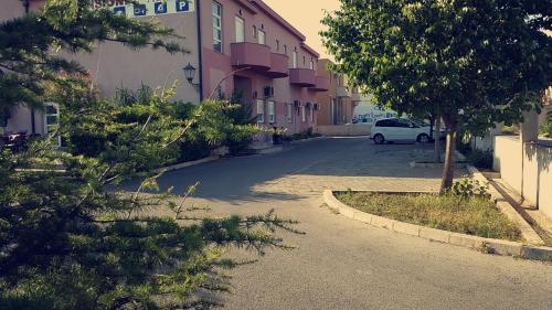 a car parked in a parking lot next to a building at Motel Aura in Mostar