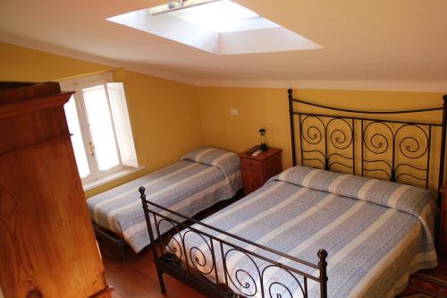 a bedroom with two beds and a window at B&B Al Borgo in Ravenna