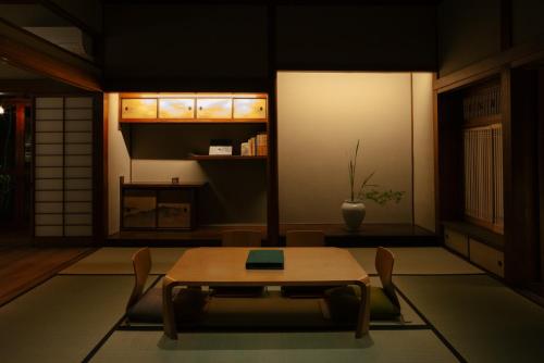 a dining room with a table and chairs in a room at willow. in Toyooka
