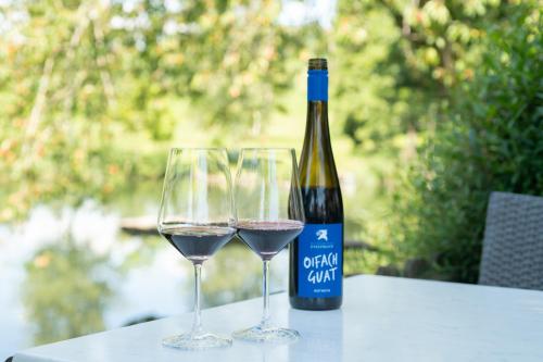 a bottle of wine and two wine glasses on a table at Landgasthof Adler in Amtzell