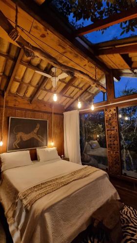 a bedroom with a bed and a large window at Casas Lago Paranoá in Paranoá