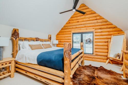 - une chambre avec un lit dans une cabane en rondins dans l'établissement Gorgeous Log Cabin Close to Town with Hot Tub, à Hailey