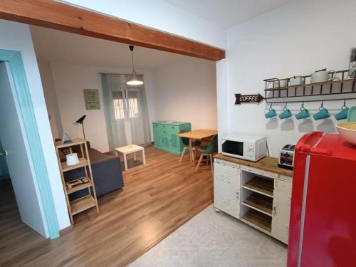 a kitchen and dining room with a red refrigerator at LA CASA DE LAS BICIS in Cádiz