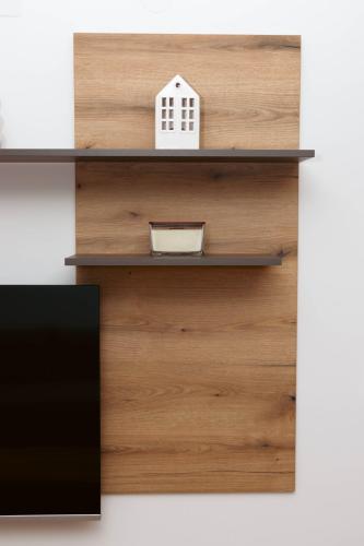 a wooden shelf with a toy house on it at Millennium Apartment in Bačka Palanka