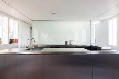 a kitchen with a sink and a large mirror at The Tonic in Shoreditch in London