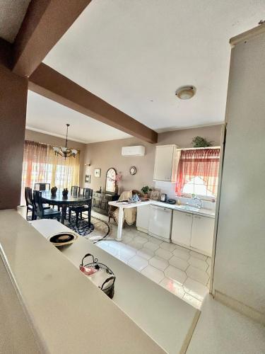 a kitchen and a living room with a table at Despina's House in Chrysoupolis