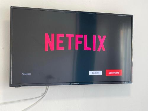 a television screen with the netflix sign on it at Afrodite II in Sarti