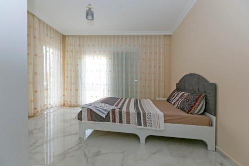 a bedroom with a bed in a room at Paradise Town Villa Legend in Belek