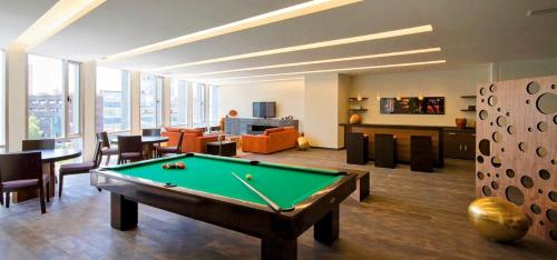 a living room with a pool table in it at AMAZING REFORMA APARTMENT, 2 brms 2 bath, AWESOME in Mexico City