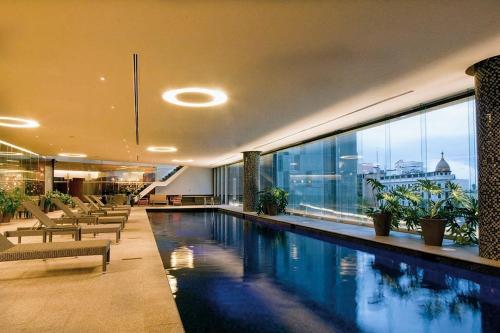 a swimming pool in a building with a large window at AMAZING REFORMA APARTMENT, 2 brms 2 bath, AWESOME in Mexico City