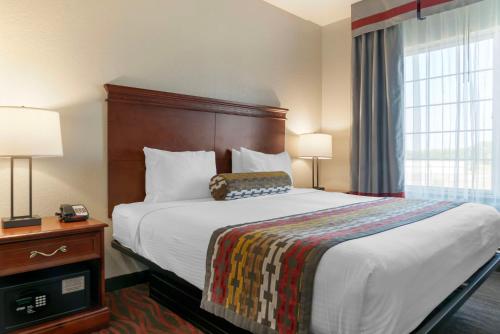 a hotel room with a large bed and a window at Best Western Executive Inn & Suites in Grand Rapids