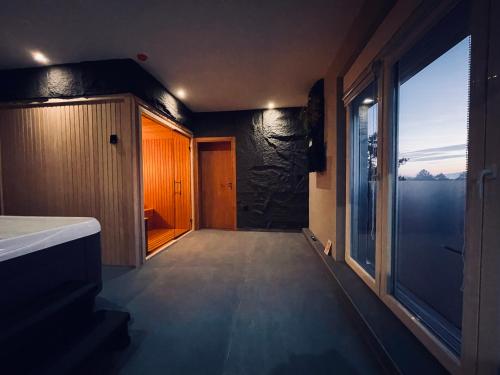 a room with a hallway with a large window at MOZAIK APARTMENTS & SPA - Modern 4-Star Apartments with Exclusive Private SPA WELLNESS in the City Center - SAUNA, JACUZZI, TURKISH BATH - FREE PARKING, Wi-FI - Rooms & Apartments Cuprija in Ćuprija