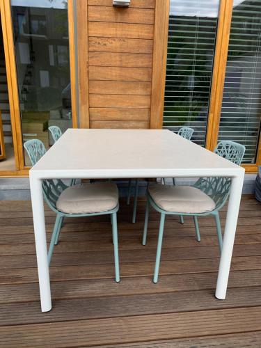 a white table and two chairs on a porch at Luxury apartment, private terrace & FREE PARKING in Antwerp