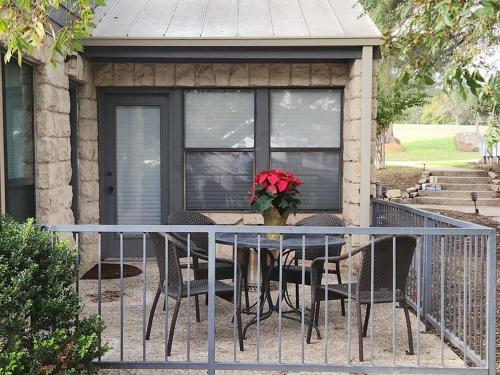 a table with chairs and a vase of flowers on a porch at Casita #5 @ Riverhill in Kerrville