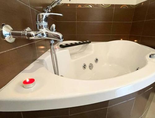 a white bath tub in a bathroom with a faucet at Casa rural Isi in Torrenueva