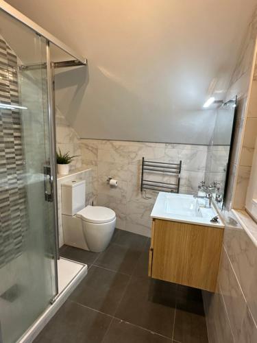 a bathroom with a toilet and a sink and a shower at Moda Gibraltar - Central Location in Gibraltar