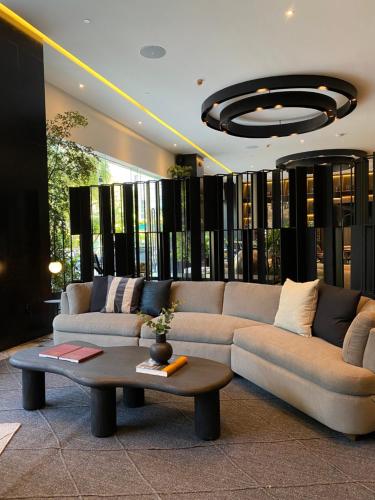 a living room with a couch and a coffee table at Grand Fiesta Americana Guadalajara Country Club in Guadalajara