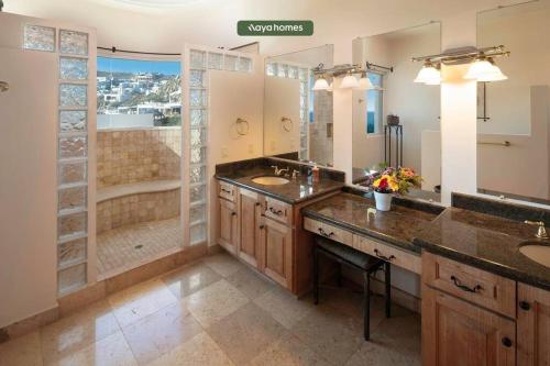 a bathroom with two sinks and a shower at Cliffside 8BR Villa with Breathtaking Views - Pool in Cabo San Lucas