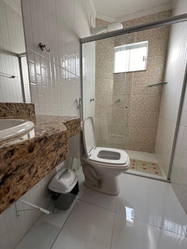 uma casa de banho com um WC, um lavatório e um chuveiro em Apartamento da Jana a 1,5km praia em Porto Seguro