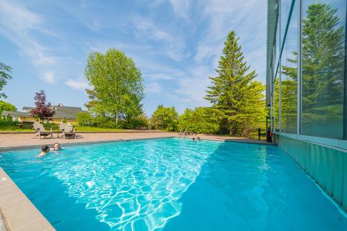 a swimming pool in a house with blue water at Horseshoe Valley Suites - The Azure in Shanty Bay