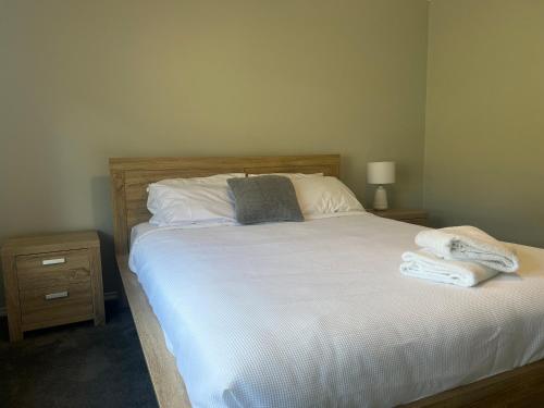 a bedroom with a bed with two towels on it at 39onDewhurst in Mudgee