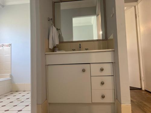 a bathroom with a white sink and a mirror at 39onDewhurst in Mudgee