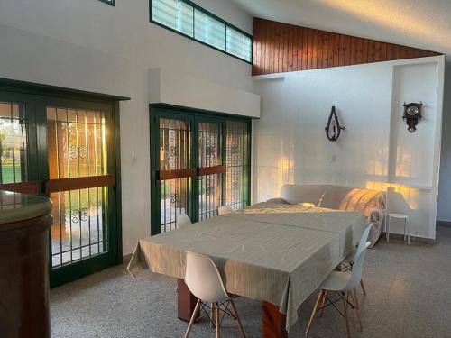 a dining room with a table and two chairs at El Descanso in Villa Lía