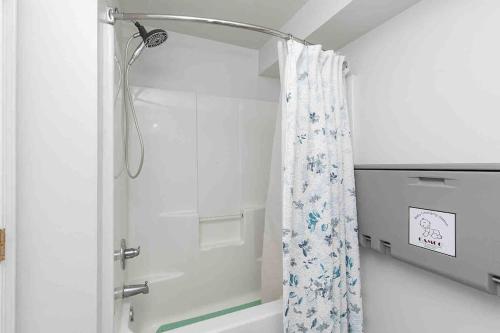 a bathroom with a shower with a shower curtain at Family Friendly Home Close to Airport and Downtown in Des Moines