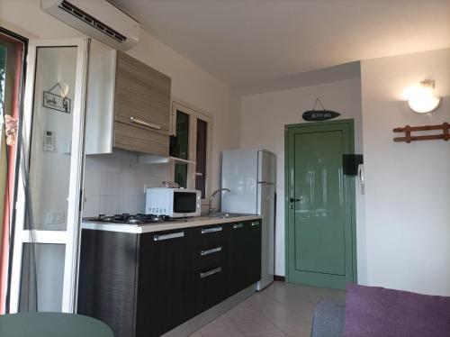 a kitchen with a stove and a microwave in it at Sal service Ibiscus Beach Ocean View Apartment in Santa Maria
