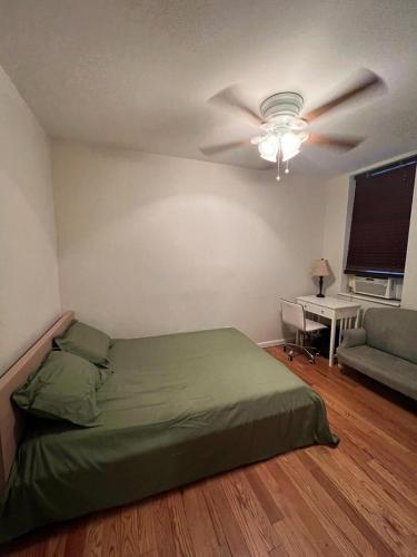a bedroom with a bed and a ceiling fan at Lovely Full Apartment x East Village (Thompkins Square Park) in New York