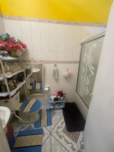 a bathroom with a chalkboard and a toilet and a sink at Jamaican J Home in Kingston