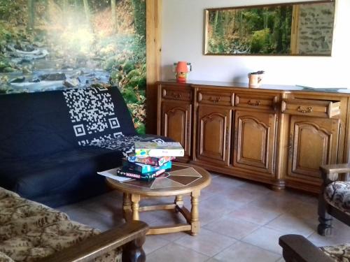 een woonkamer met een bank en een tafel bij Gîte Saint-Léonard-des-Bois, 5 pièces, 7 personnes - FR-1-410-179 in Saint-Léonard-des-Bois