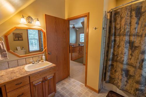 a bathroom with a sink and a shower at Nature's Getaway Mountain Resort- Cozy Bear Cabin in Nordegg