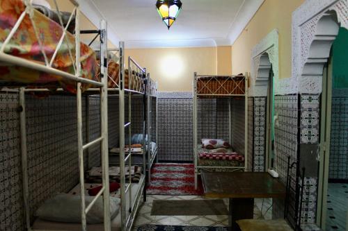 a room with many bunk beds in a room at Hostel kif kif annex in Marrakech