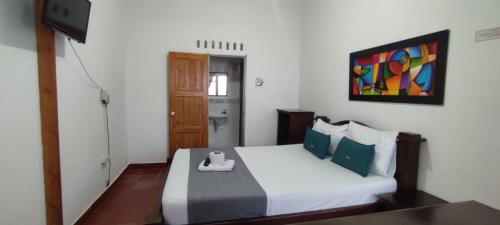 a bedroom with a bed with a scale on it at Hotel Villa Ángel in Neiva