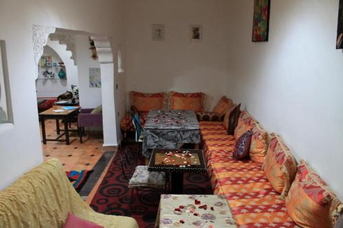 a living room with a couch and a table at Hostel kif kif annex in Marrakesh