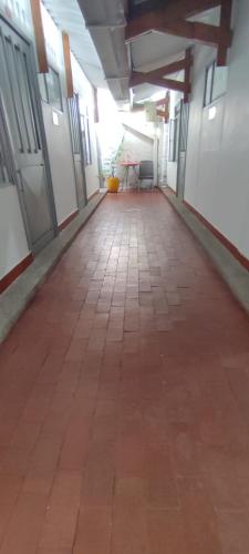 an empty hallway of a building with a table at Hotel Villa Ángel in Neiva