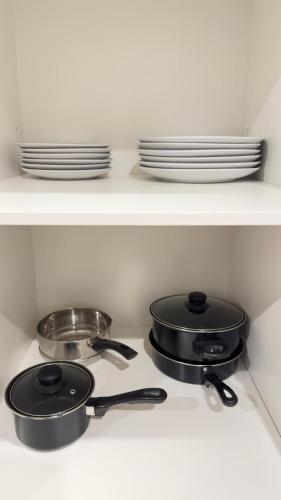 two pots and pans on a stove in a kitchen at Home in Wyndham Vale (Manor Lakes) Melbourne in Wyndham Vale