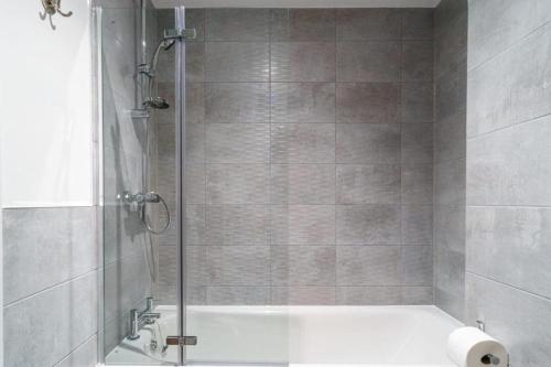 a shower with a glass door in a bathroom at Stylish & Spacious Salford Quays one bedroom high floor apartment with balcony in Manchester