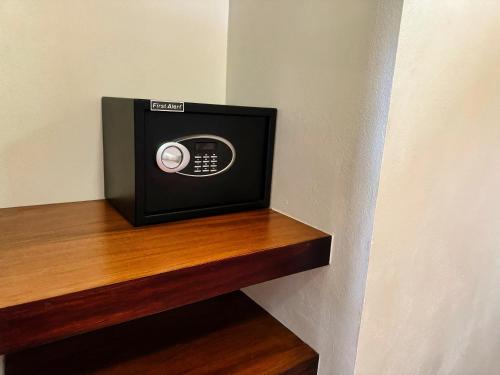 a microwave sitting on top of a wooden shelf at Brahman Bungalows on Pavones Point in Pavones
