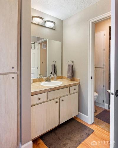a bathroom with a sink and a mirror at Giant Steps #43 W Hot Tub, Sauna, And Game Room! in Brian Head