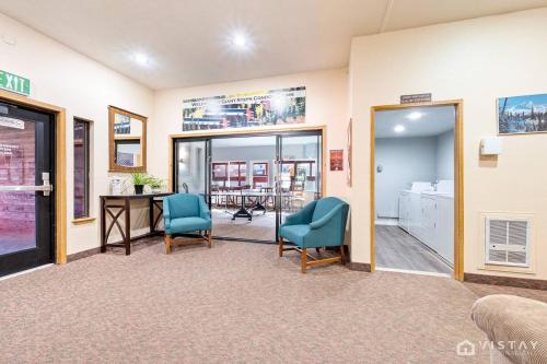 a waiting room with two blue chairs and a table at Giant Steps #43 W Hot Tub, Sauna, And Game Room! in Brian Head