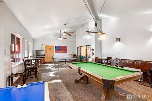 a living room with a pool table and tables at Giant Steps #43 W Hot Tub, Sauna, And Game Room! in Brian Head