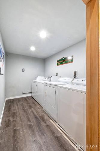 a laundry room with white washers and dryers at Giant Steps #43 W Hot Tub, Sauna, And Game Room! in Brian Head